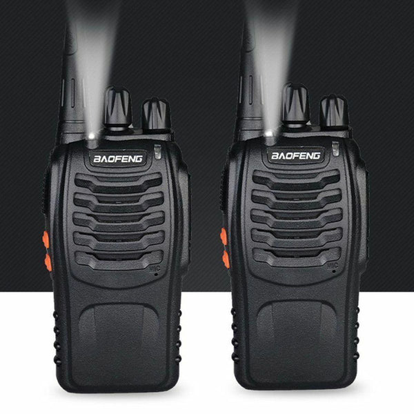 Two black walkie talkies with visible branding on a dark background