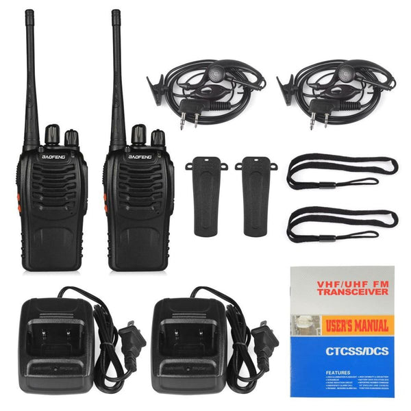 Two walkie-talkies with accessories and user manual on a white background