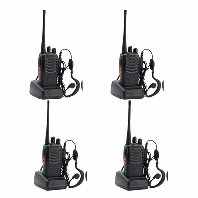 Four black walkie-talkies with earpieces on a white background